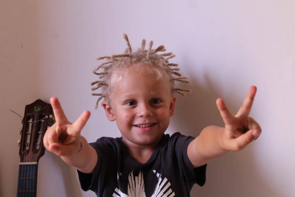 Enfant avec des dreadlocks bien faites par une coiffeuse 